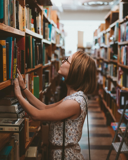 Woman in front of bookshelf
